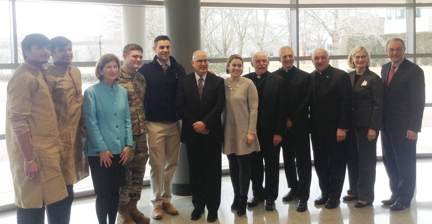 Some of the 188 attendees representing 30 different faith congregations gather for a photo, above, during the annual Interfaith Prayer Breakfast, held at Bryant University on Feb. 12.
